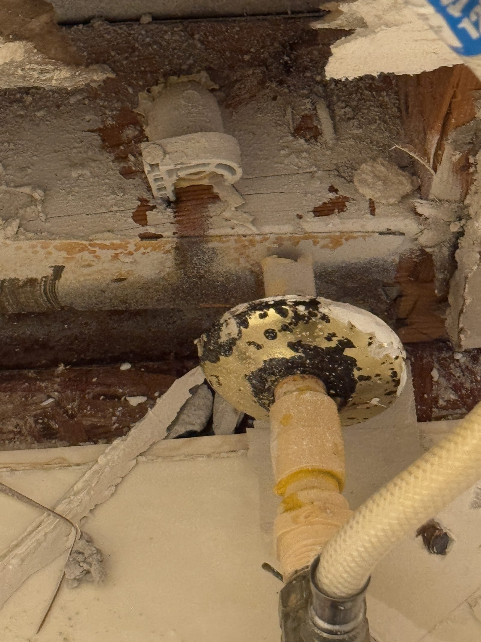 Corroded pipe fitting found during a burst pipe inspection in a Charlotte NC home